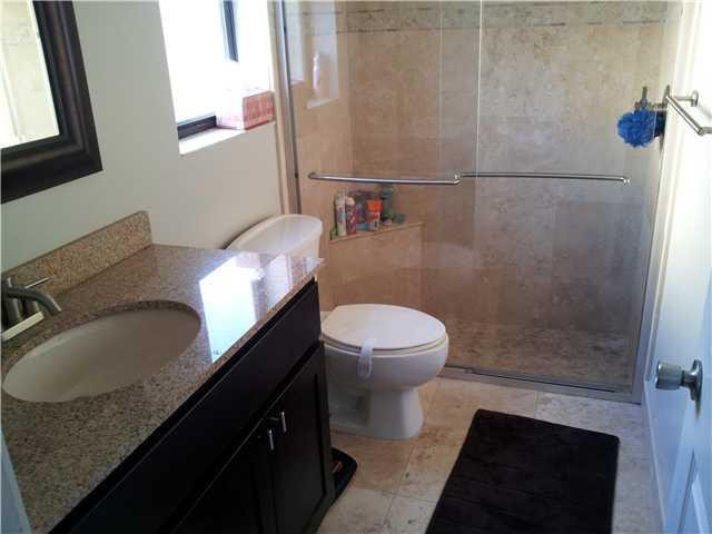 417 Apache Lane Boca Raton, FL 33487 - Photo 6 of 13 a bathroom with a granite countertop sink toilet and shower