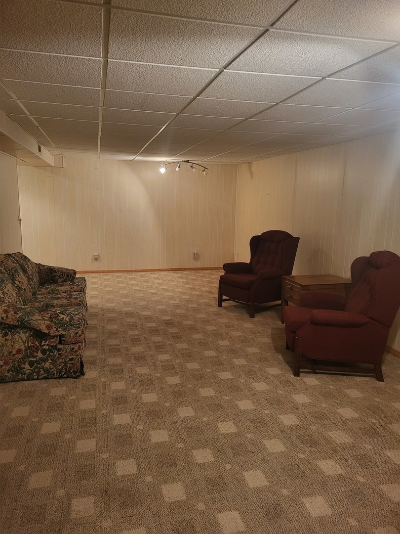 434 East Exchange Street, Unit 2 Sycamore, IL 60178 - Photo 15 of 15 a living room with furniture and a refrigerator