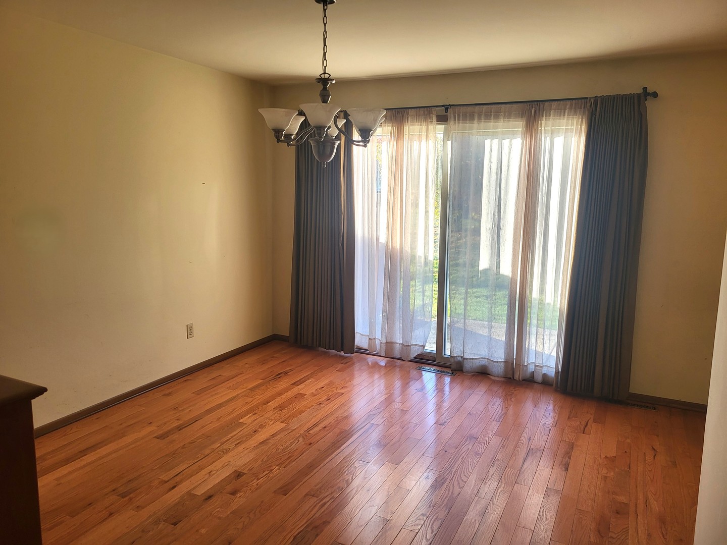 434 East Exchange Street, Unit 2 Sycamore, IL 60178 - Photo 5 of 15 a view of an empty room with wooden floor and a window