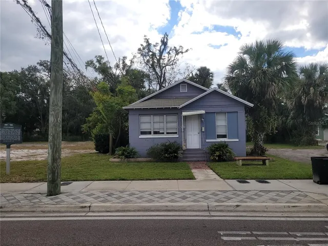 a view of a house with a yard plants next to a yard