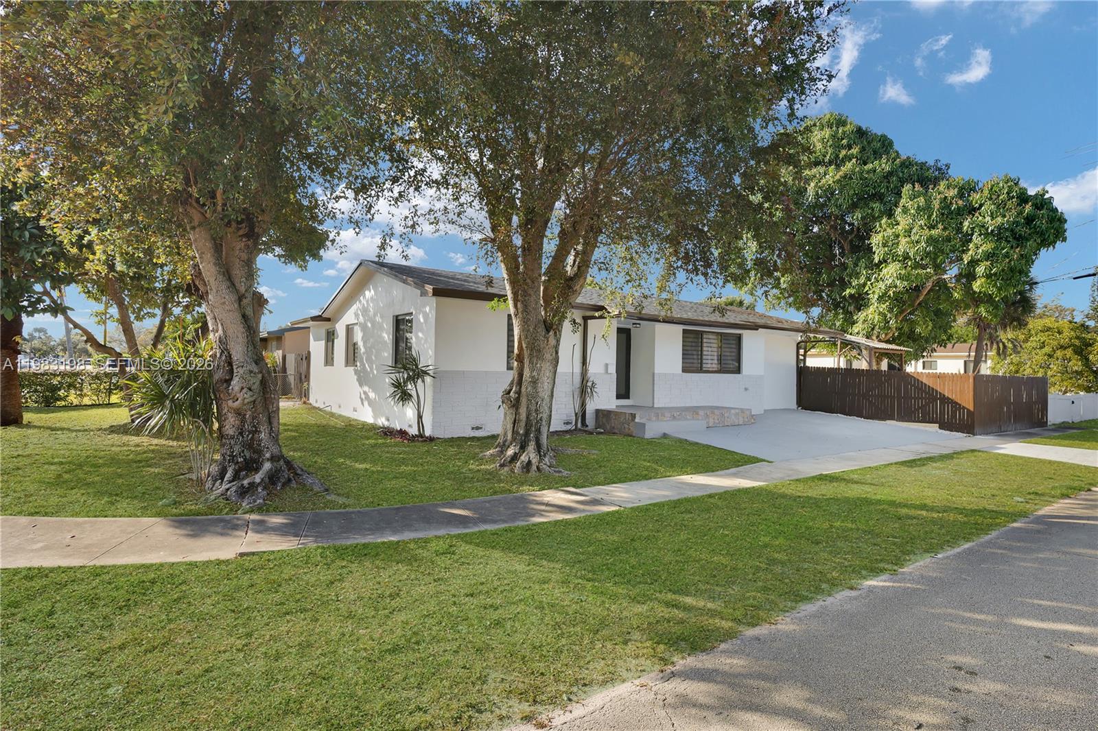7501 Raleigh Street Hollywood, FL 33024 - Photo 17 of 21 a white house that has a tree in front of a house