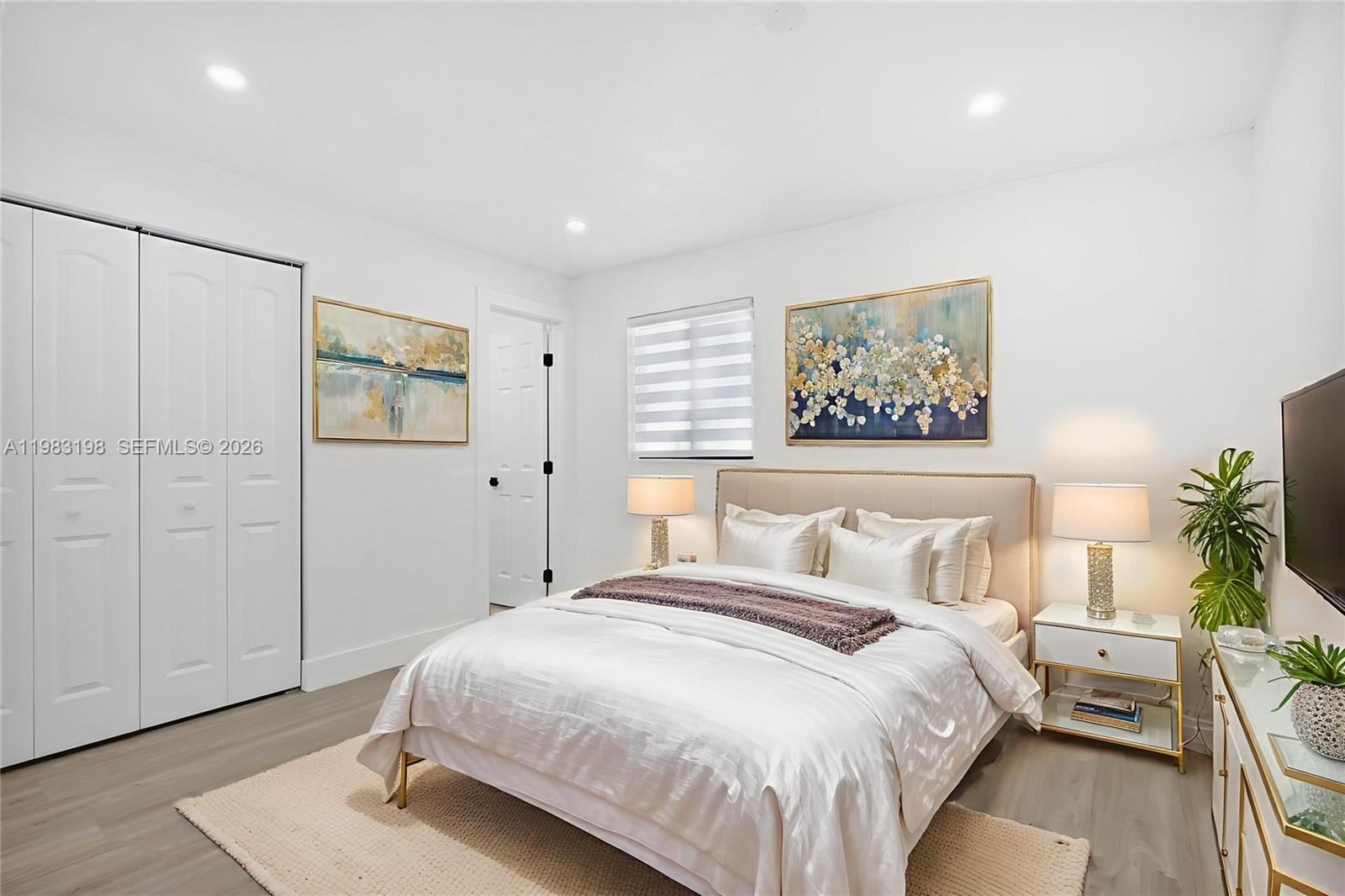 7501 Raleigh Street Hollywood, FL 33024 - Photo 10 of 21 a bedroom with a large bed and a couch