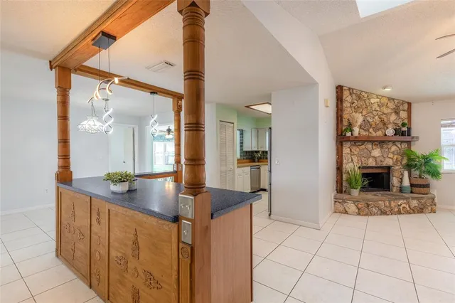 a kitchen with stainless steel appliances kitchen island granite countertop a refrigerator a stove and a sink with granite countertops