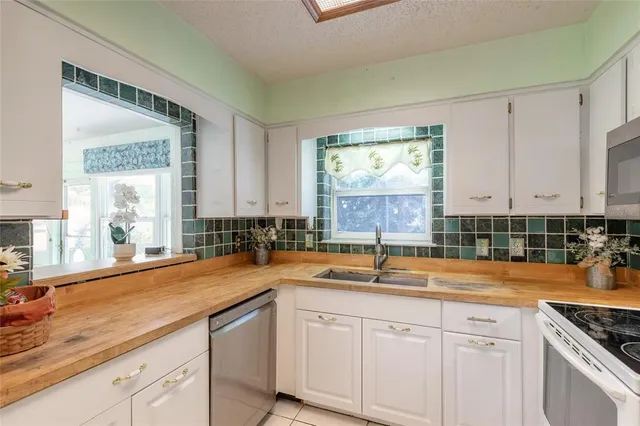 a kitchen with a refrigerator a sink and cabinets