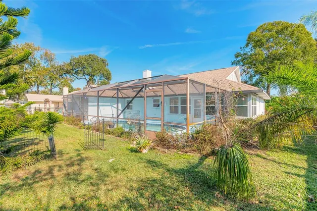 a front view of a house with swimming pool and furniture