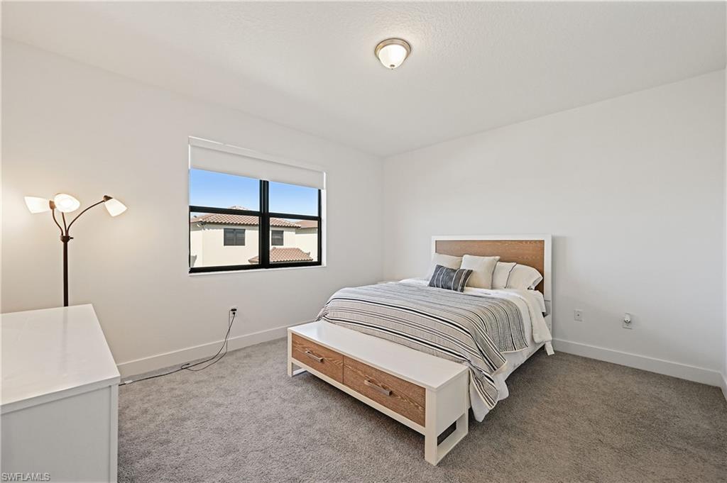 5617 Cobalto Way Avenue Immokalee, FL 34142 - Photo 15 of 35 a bedroom with a bed and a window