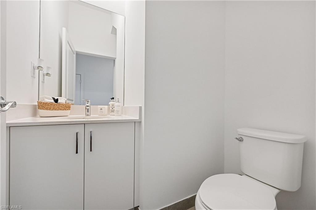 5617 Cobalto Way Avenue Immokalee, FL 34142 - Photo 28 of 35 a bathroom with a toilet sink and mirror