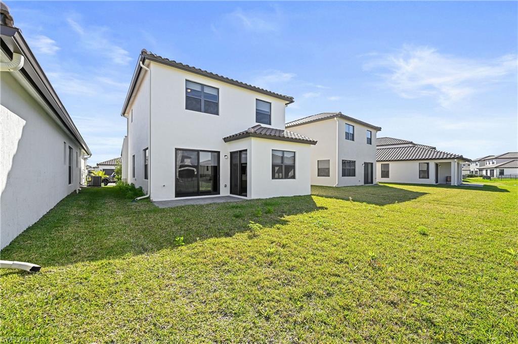 5617 Cobalto Way Avenue Immokalee, FL 34142 - Photo 34 of 35 a front view of a house with a garden