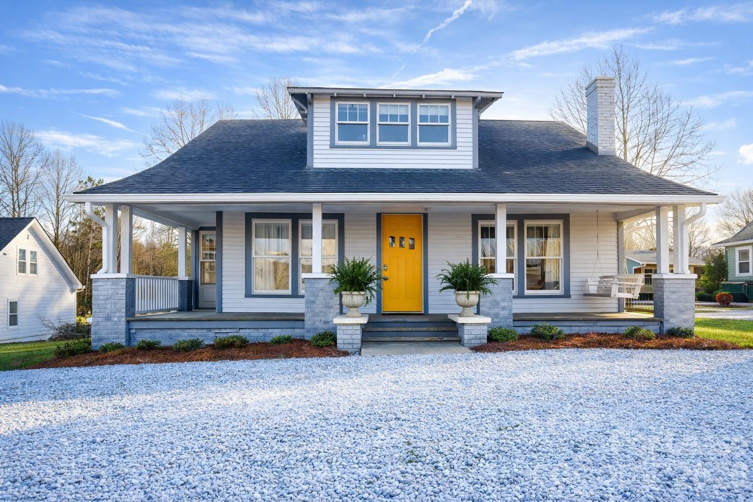 a view of a house with a yard porch and sitting area