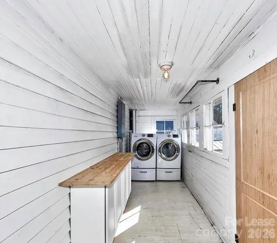 a view of a storage and utility room with washer and dryer