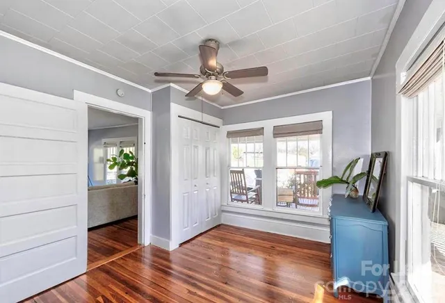 a view of an entryway with wooden floor and a livingroom