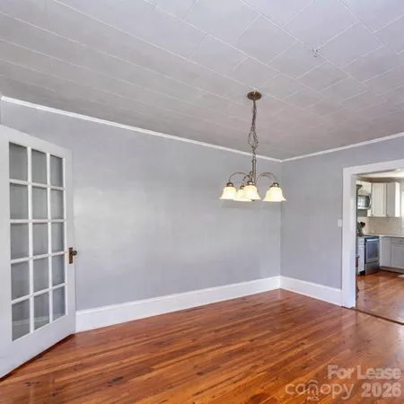 a view of a room with wooden floor staircase and a window