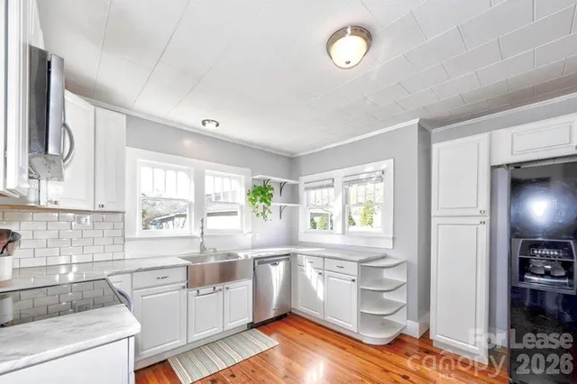 a kitchen with a window a sink and a refrigerator