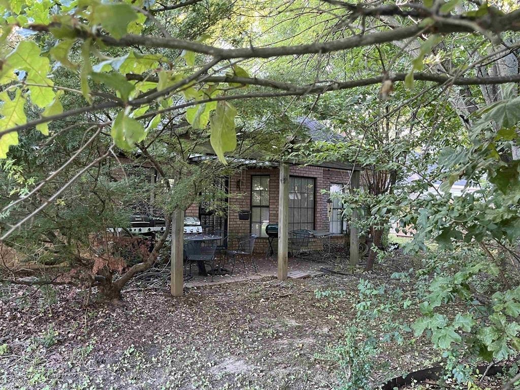 4066 Canada Road Arlington, TN 38002 - Photo 3 of 5 a backyard of a house with barbeque oven table and chairs