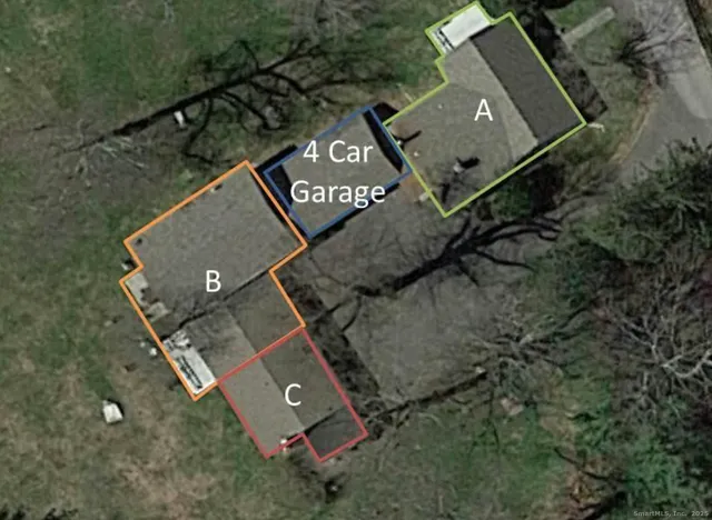 an aerial view of a house with a yard