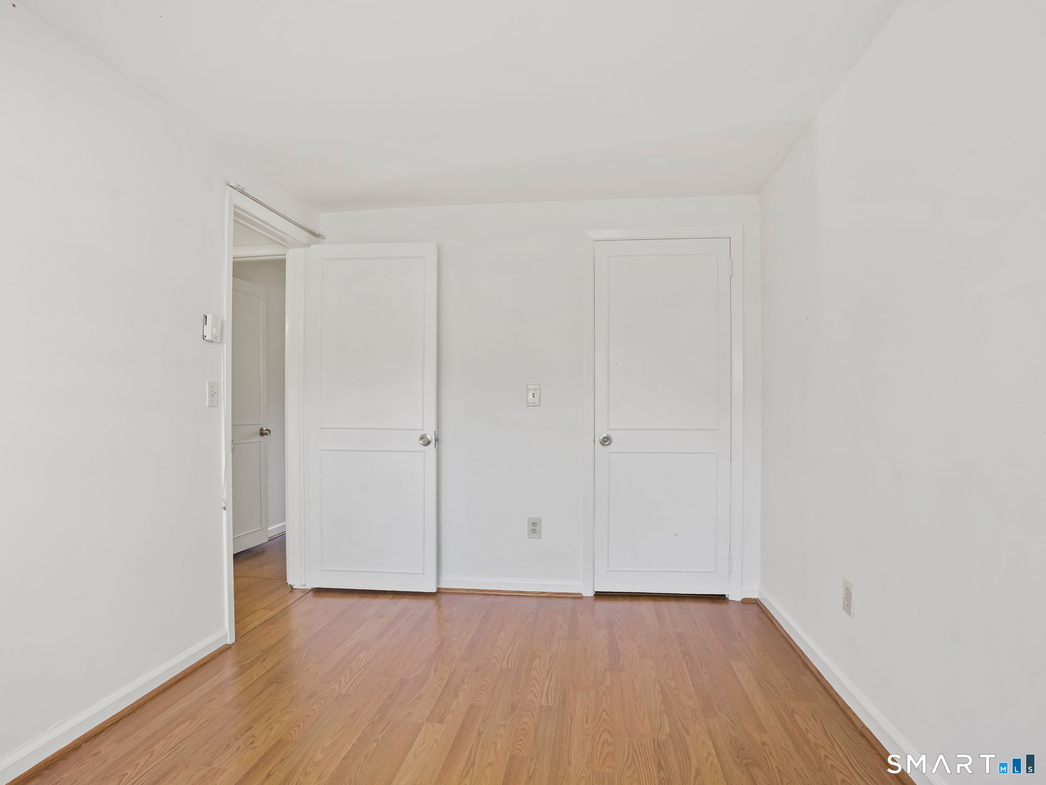 21 Richdale Drive, Unit C Wilton, CT 06897 - Photo 4 of 10 a view of an empty room with wooden floor
