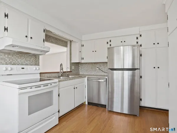 a kitchen with appliances a sink and a stove