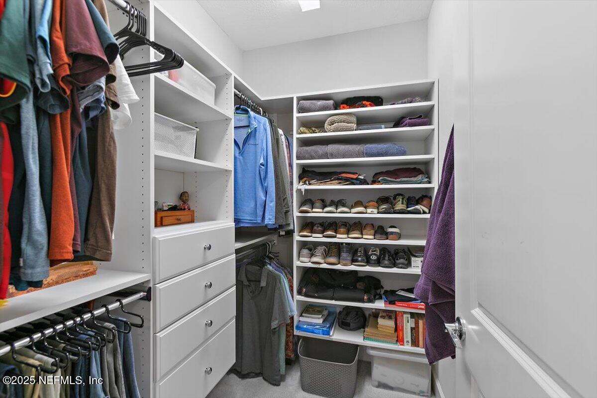 169 Rivercliff Trail St. Augustine, FL 32092 - Photo 23 of 49 a view of walk in closet with clothes and shoes