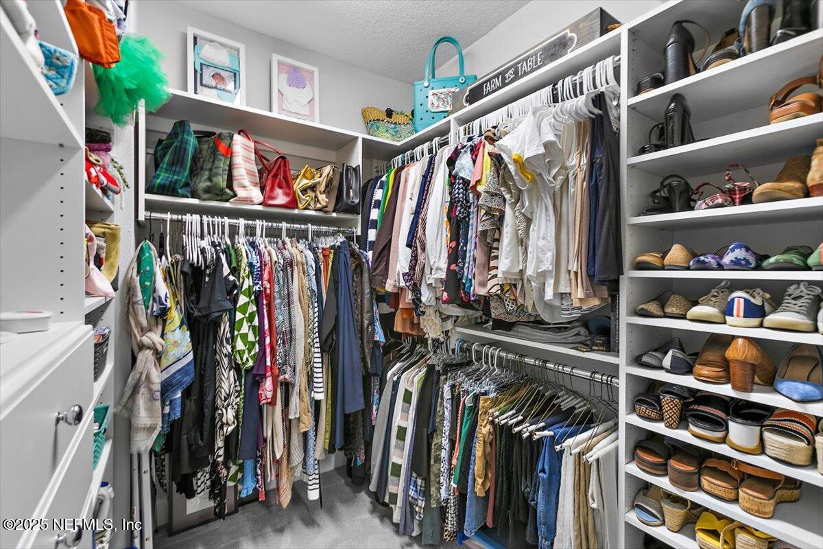 169 Rivercliff Trail St. Augustine, FL 32092 - Photo 24 of 49 a view of walk in closet with clothes and shoes
