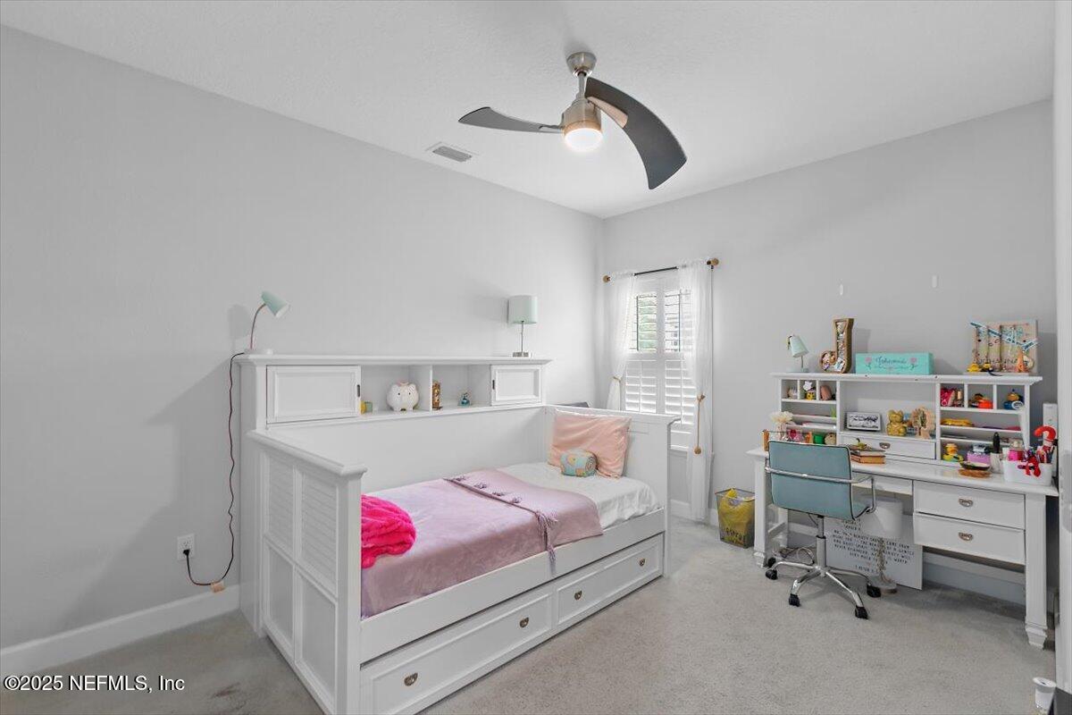 169 Rivercliff Trail St. Augustine, FL 32092 - Photo 27 of 49 a bedroom with a bed and a book shelf