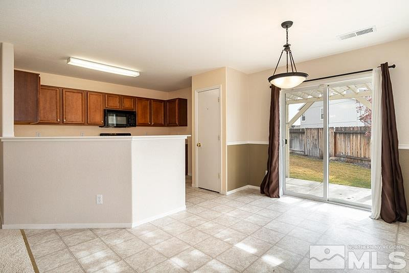 7650 Bichon Street Reno, NV 89506 - Photo 4 of 15 a kitchen with stainless steel appliances granite countertop a refrigerator and a granite counter tops