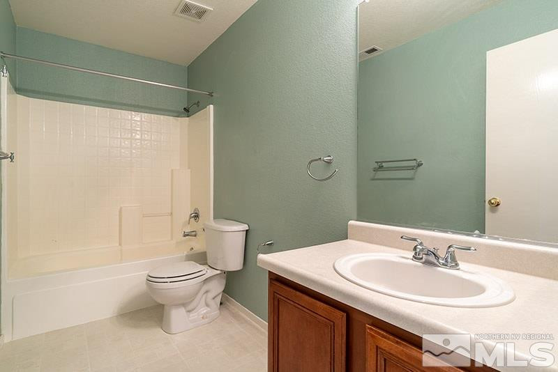 7650 Bichon Street Reno, NV 89506 - Photo 9 of 15 a bathroom with a sink toilet and shower