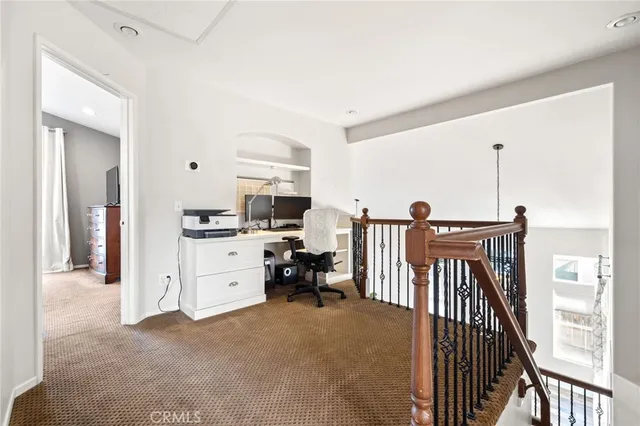 a view of a kitchen with furniture and electronic appliances