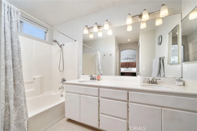 a bathroom with a sink vanity tub and a mirror