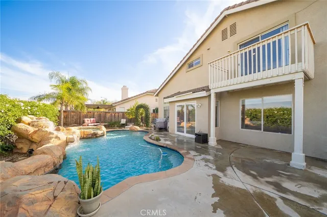 a view of a house with backyard porch and sitting area