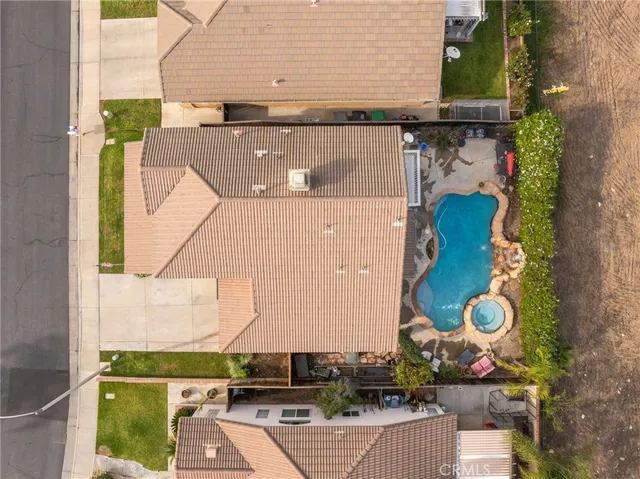an aerial view of a house with a yard and large trees