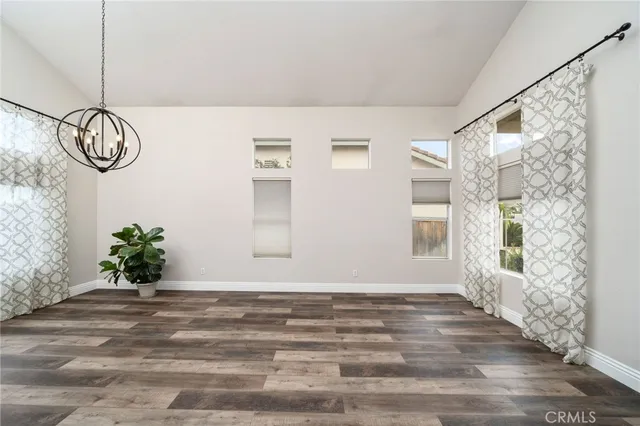 a view of a room with wooden floor and windows