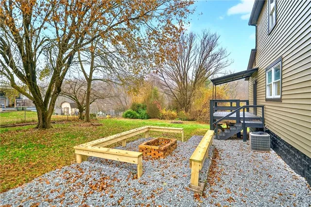 a swimming pool with outdoor seating and yard