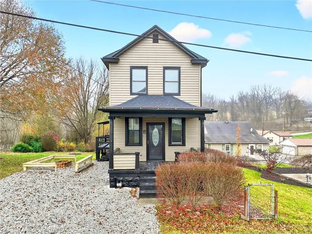 a front view of a house with garden