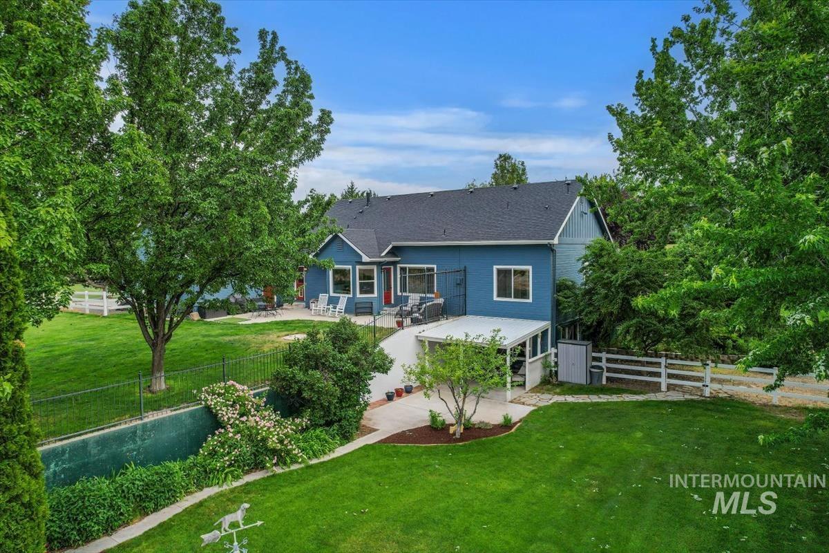 10462 West Lanktree Gulch Road Star, ID 83669 - Photo 42 of 48 Exterior of a two-story residence featuring blue siding, a dark shingle roof, and multiple windows