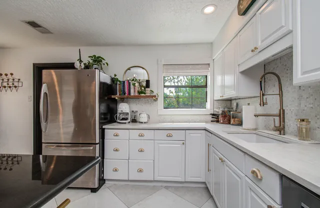 a kitchen with appliances a sink and cabinets