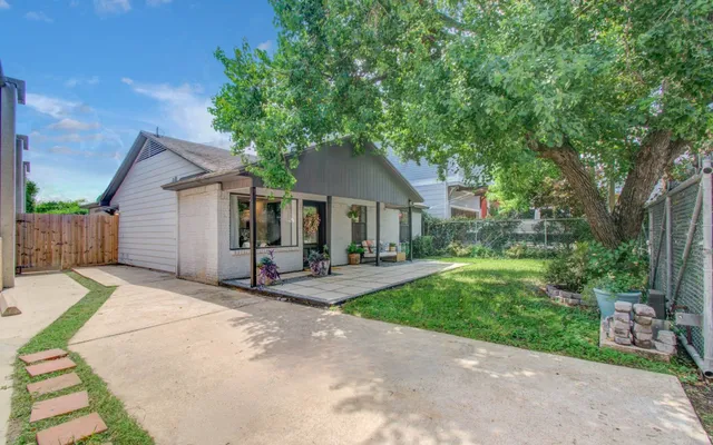 a front view of a house with yard patio and green space