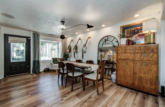 a view of a dining room with furniture and wooden floor