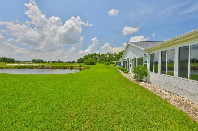 an aerial view of residential houses with outdoor space and swimming pool