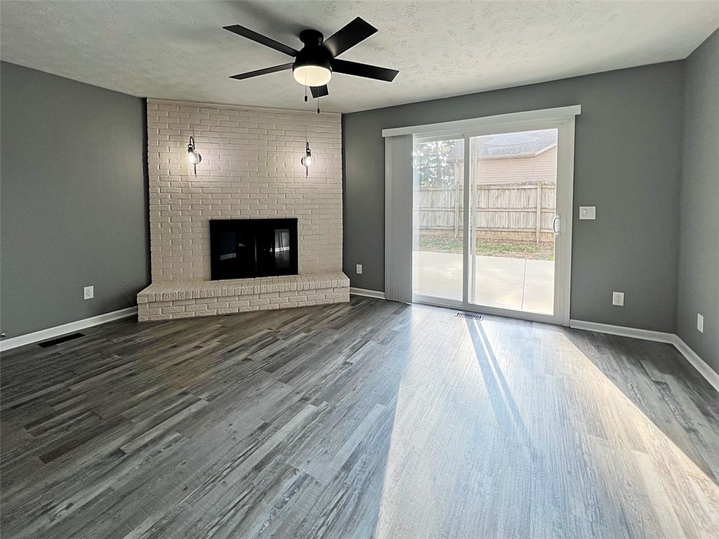 920 North Dorset Road, Unit 920 Troy, OH 45373 - Photo 4 of 18 This inviting living area features a charming fireplace and bright patio access.