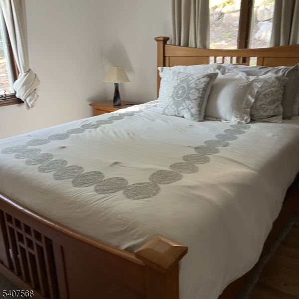 6 Jans Way Andover, NJ 07821 - Photo 16 of 23 a bed sitting in a bedroom next to a window