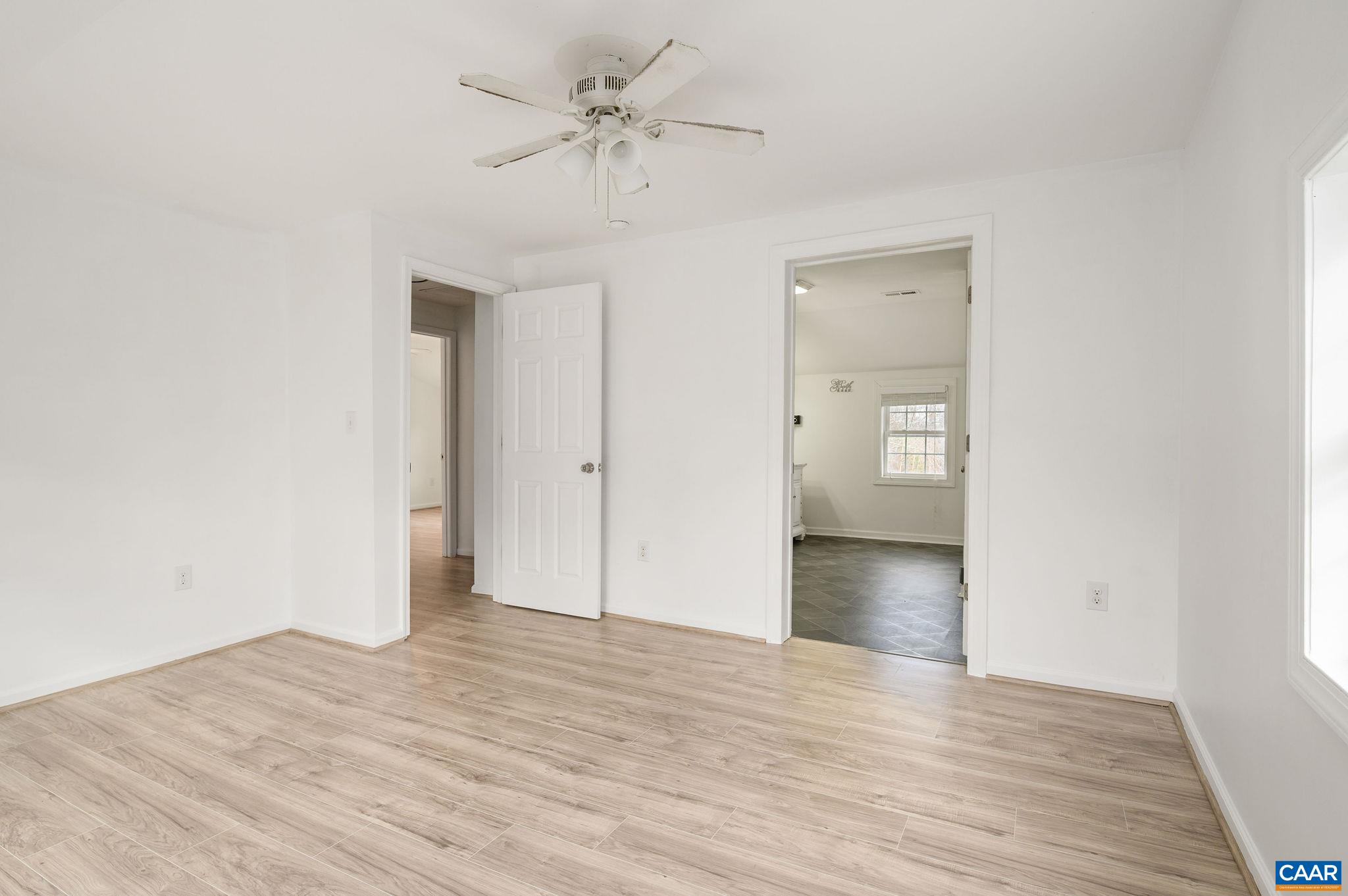 5029 Green Creek Road Schuyler, VA 22969 - Photo 13 of 27 a view of empty room with wooden floor and ceiling fan