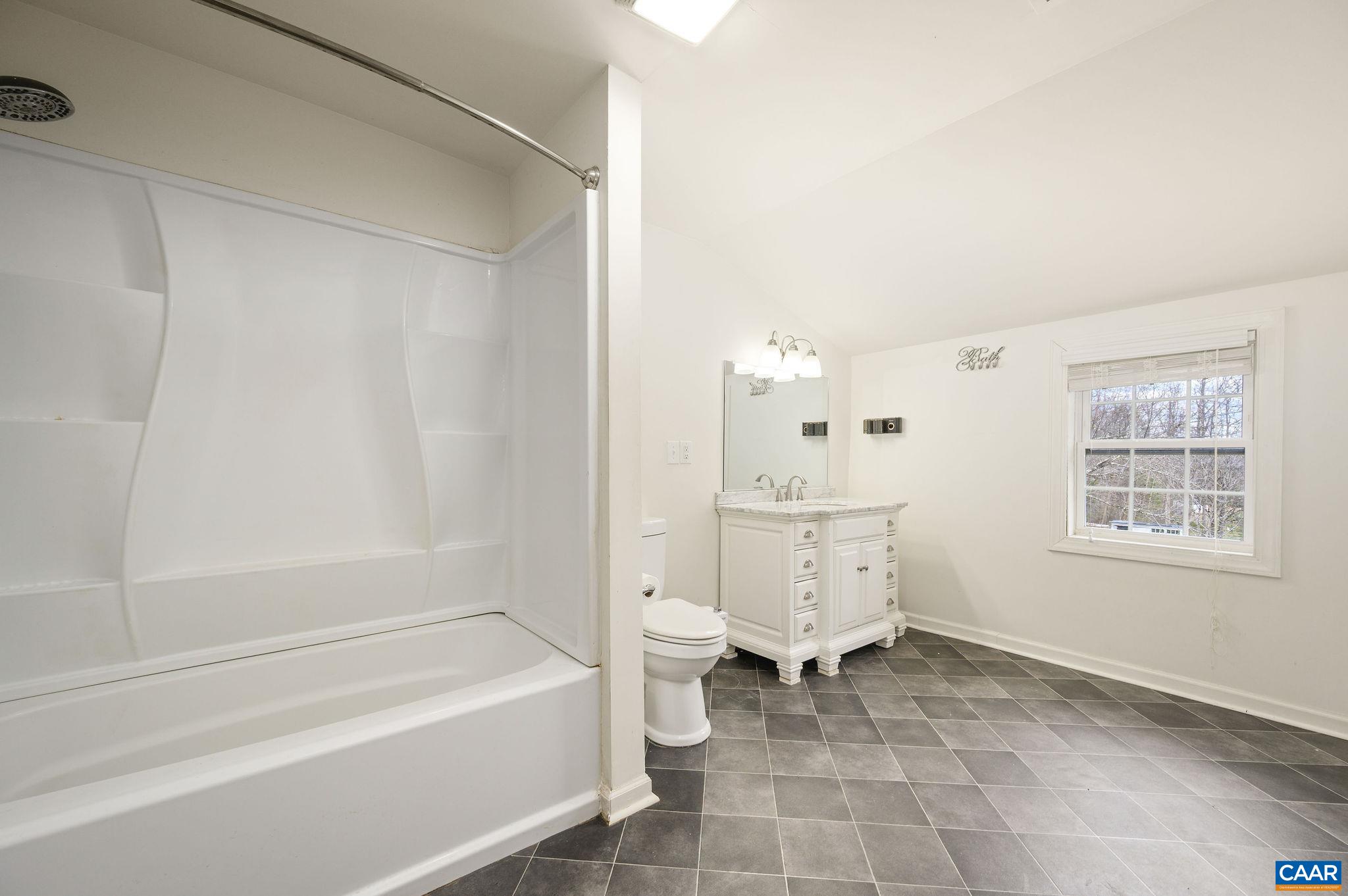 5029 Green Creek Road Schuyler, VA 22969 - Photo 14 of 27 a spacious bathroom with a bathtub toilet and a shower