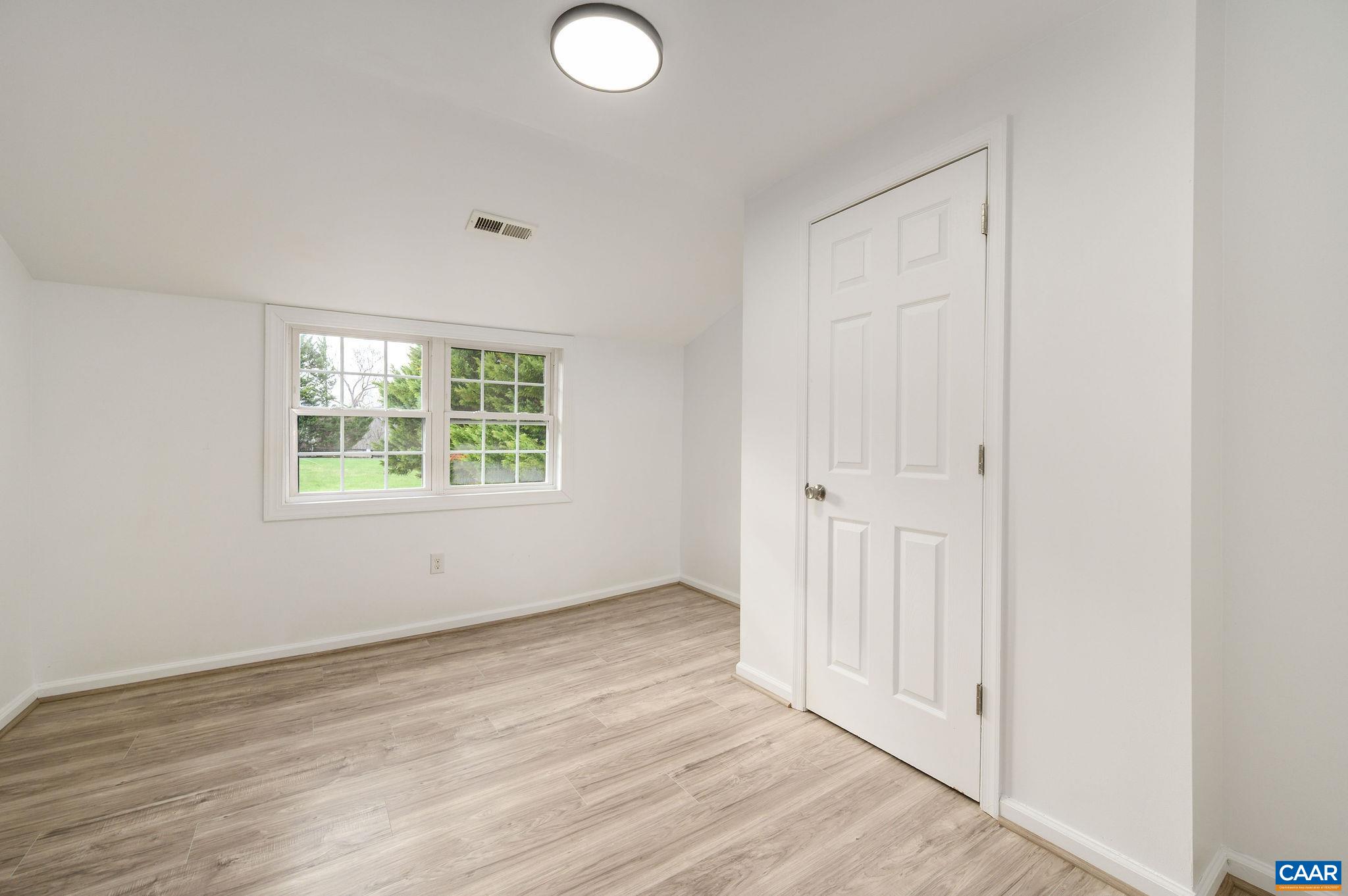 5029 Green Creek Road Schuyler, VA 22969 - Photo 16 of 27 an empty room with wooden floor and windows