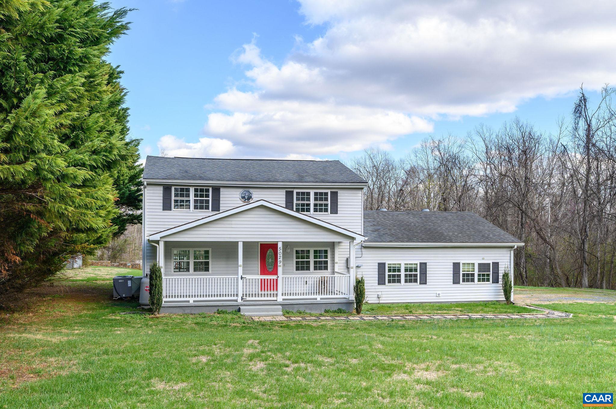5029 Green Creek Road Schuyler, VA 22969 - Photo 18 of 27 a front view of a house with a garden and trees