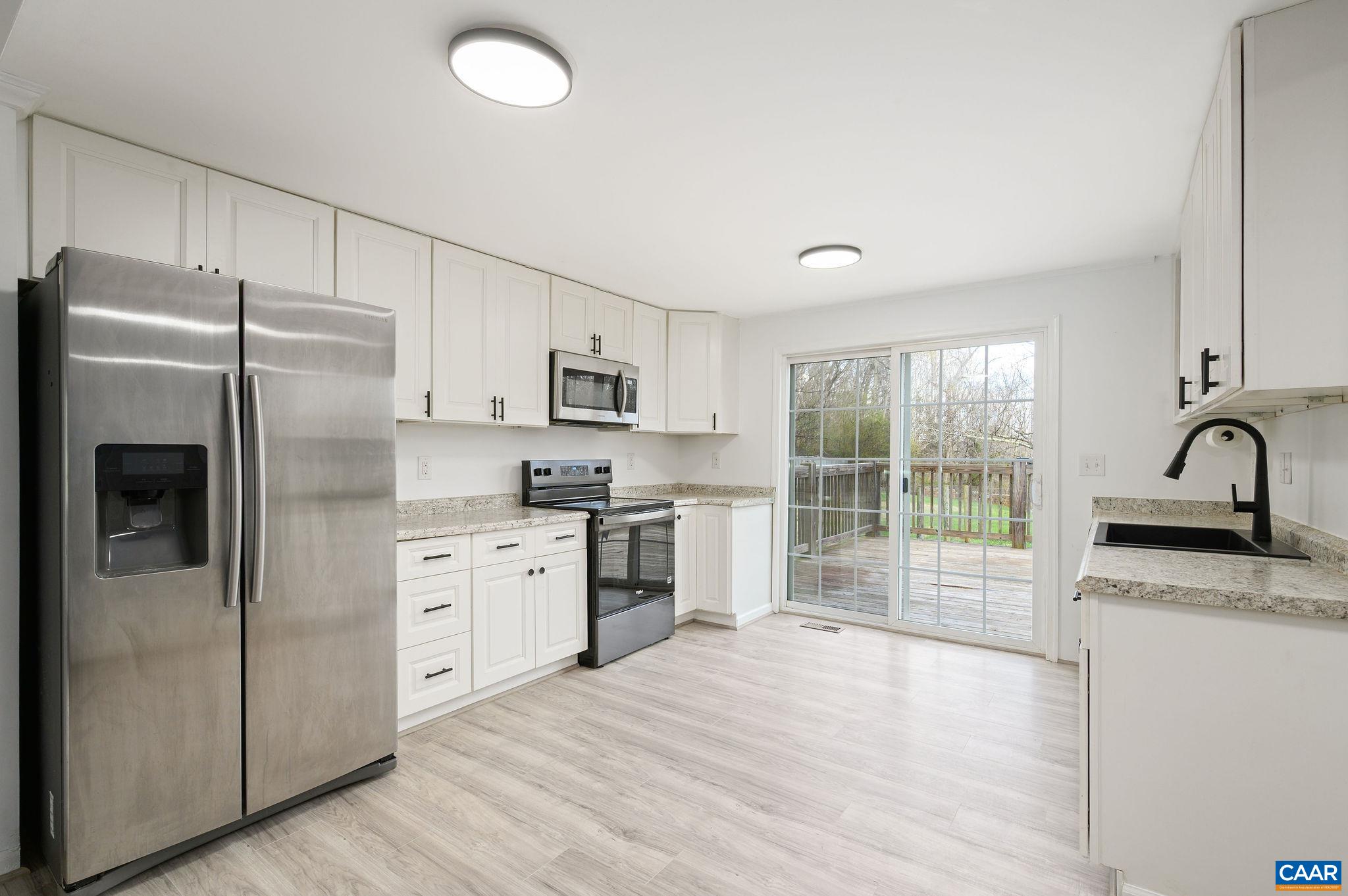 5029 Green Creek Road Schuyler, VA 22969 - Photo 6 of 27 a kitchen with granite countertop a refrigerator stove top oven and sink
