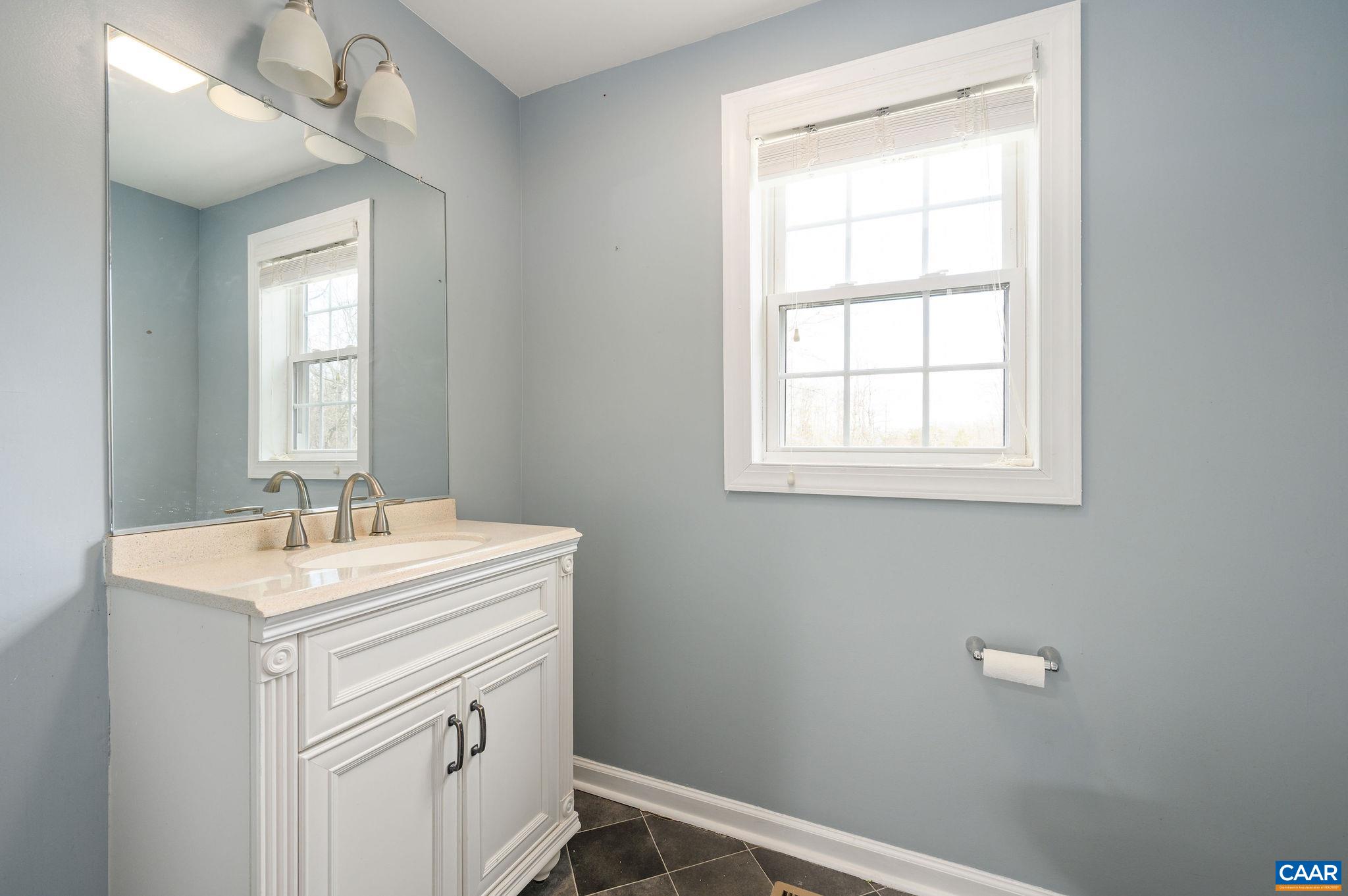 5029 Green Creek Road Schuyler, VA 22969 - Photo 10 of 27 a bathroom with a sink a vanity and a window