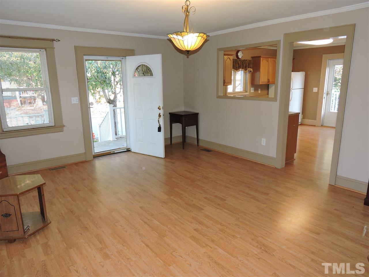 128 Allgood Street Roxboro, NC 27573 - Photo 2 of 17 a view of an empty room with a window and wooden floor