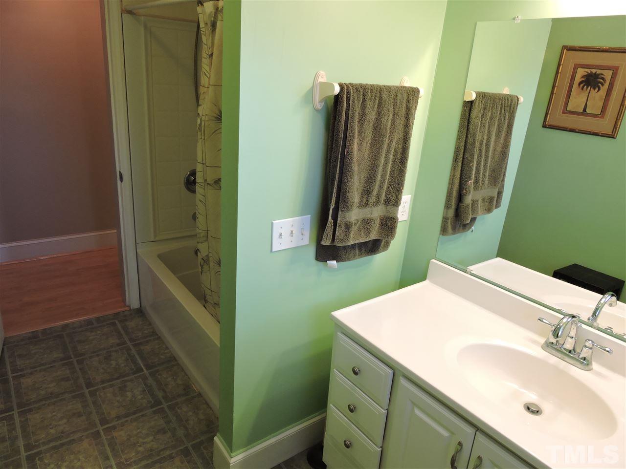 128 Allgood Street Roxboro, NC 27573 - Photo 11 of 17 a bathroom with a sink a toilet and a mirror