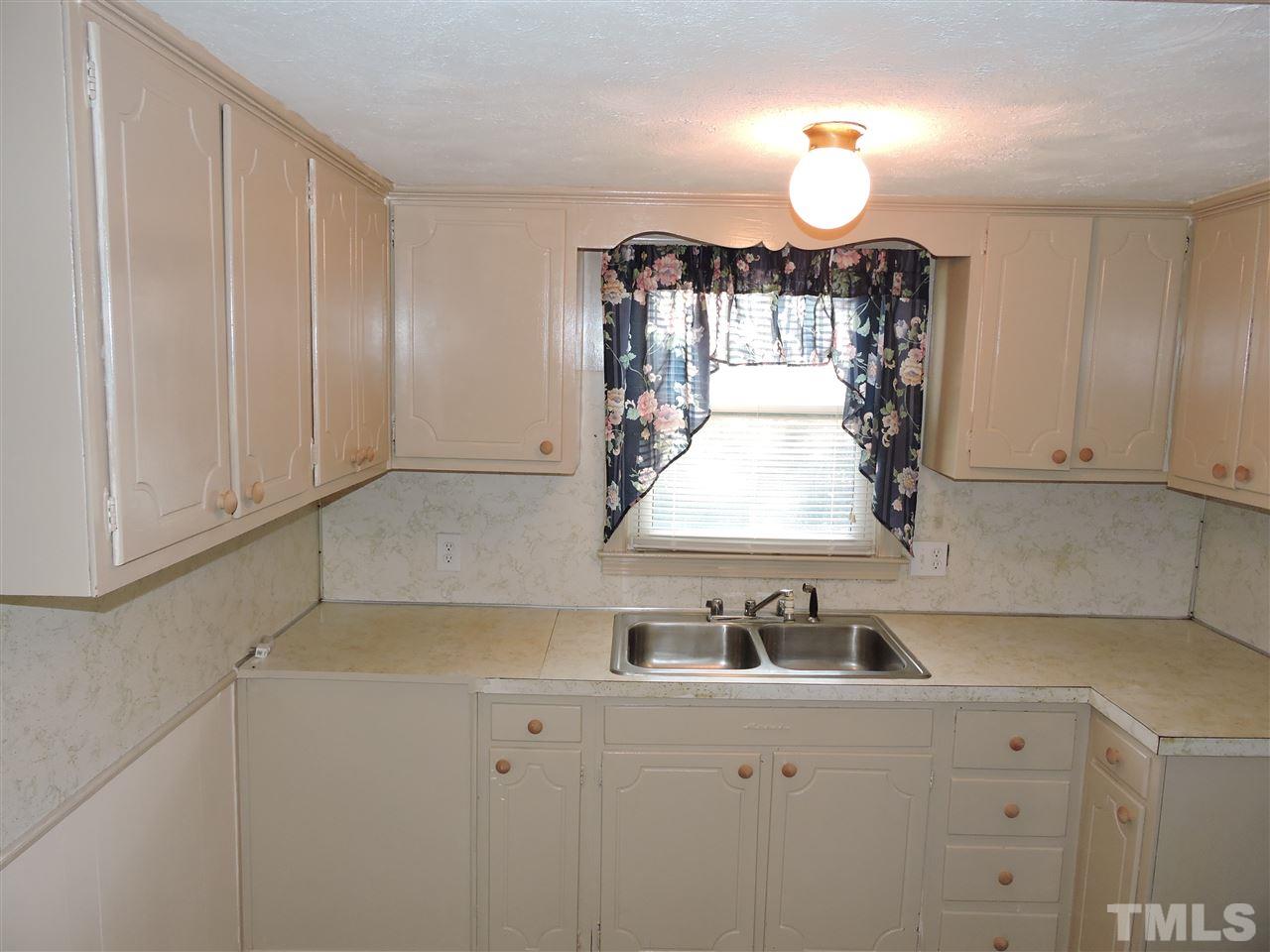 128 Allgood Street Roxboro, NC 27573 - Photo 16 of 17 a kitchen with a sink and cabinets