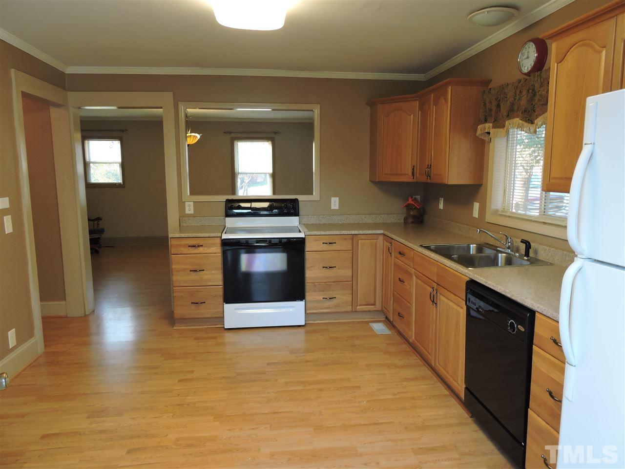 128 Allgood Street Roxboro, NC 27573 - Photo 3 of 17 a kitchen with stainless steel appliances granite countertop a stove a sink and a refrigerator